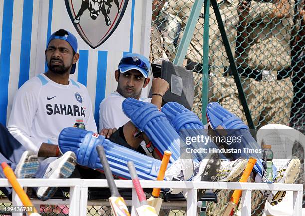 Indian cricket players Gautam Gambhir and Praveen Kumar in a relax during a practice session at Rajiv Gandhi Stadium on October 13, 2011 in...