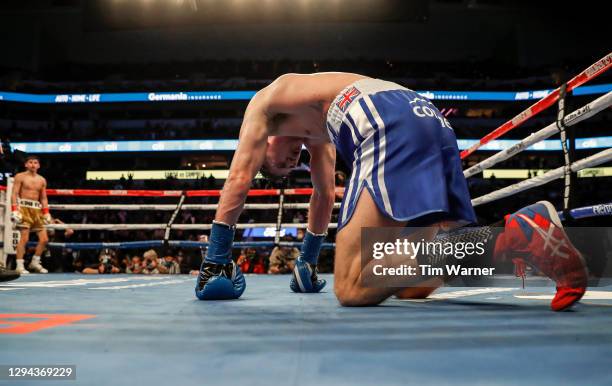 Luke Campbell kneels on the canvas after a knock down while Ryan Garcia stands in the neutral corner during the WBC Interim Lightweight Title fight...