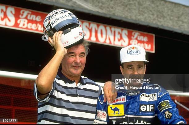 Portrait of Williams Renault driver Nigel Mansell of Great Britain with Nottingham Forest Manager Brian Clough at the City Ground in Nottingham,...