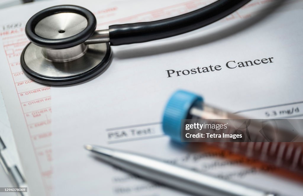 Studio shot of prostate cancer document, stethoscope and blood sample
