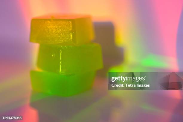 stack of edible cannabis gummies in rainbow light - jelly sweet stock pictures, royalty-free photos & images