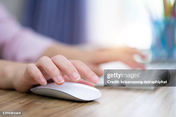 business women working on computers - mouse pad stock pictures, royalty-free photos & images