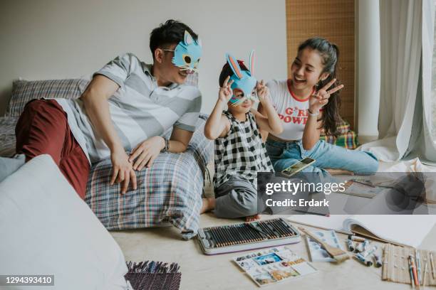 i love rabbit, little cute said with her father and sister while playing game together-stock photo - rabbit mask stock pictures, royalty-free photos & images