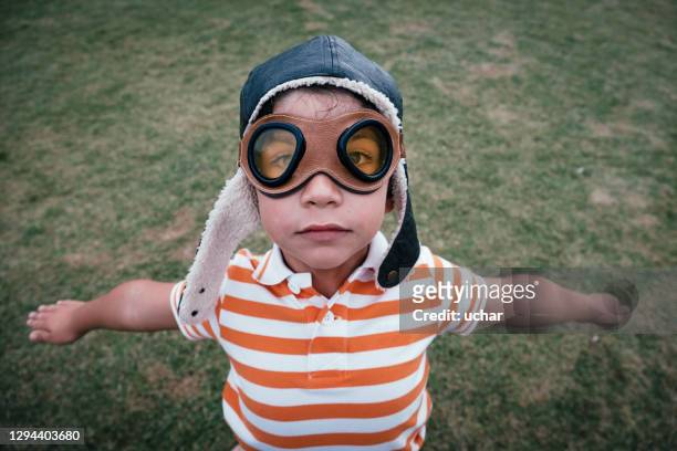 kleiner junge mit brille bilder fliegen - fliegermütze stock-fotos und bilder