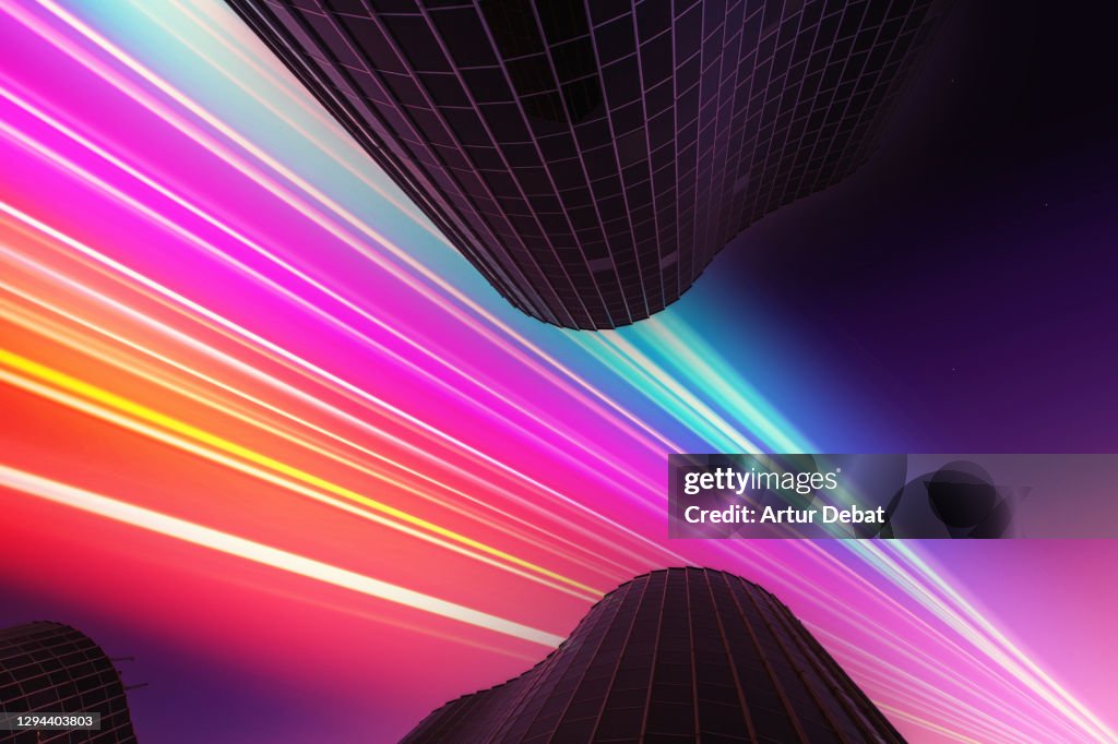 Modern glass skyscrapers from directly below with futuristic and fast colorful light trail.