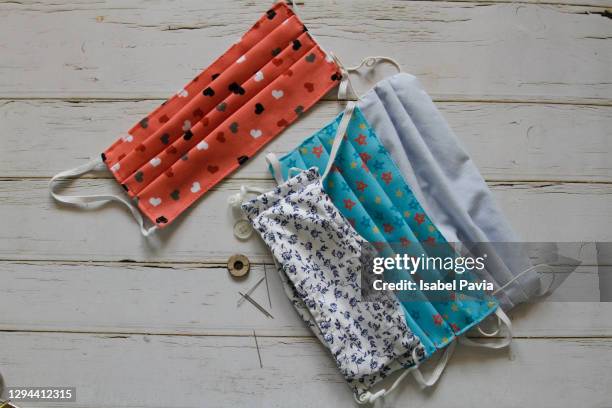 sewing tools and home made face masks on wooden background - ribbon sewing item stock pictures, royalty-free photos & images