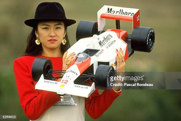 Glamour girl holds a McLaren Honda model car before the Japanese Grand Prix at the Suzuka circuit in Japan. \ Mandatory Credit: Pascal...