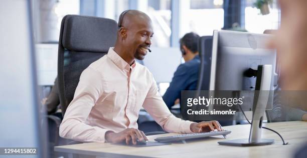 mature man working in call centre - hairless mouse stock pictures, royalty-free photos & images