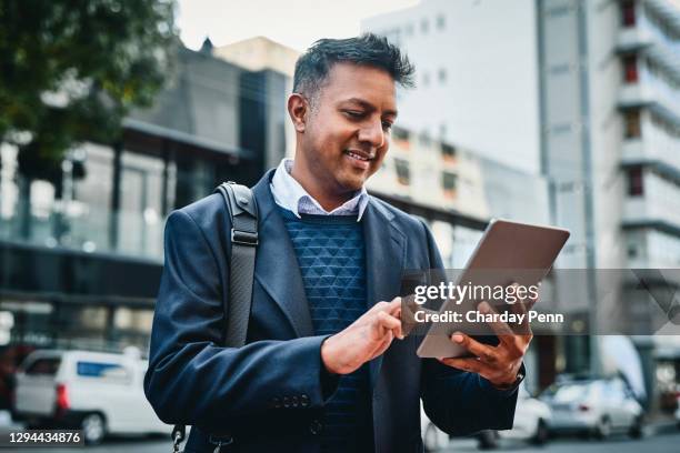 the device that keeps his day on track - business man on the move stock pictures, royalty-free photos & images