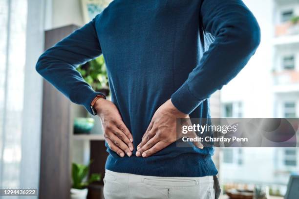 the tension is really turned up today - back pain man stock pictures, royalty-free photos & images