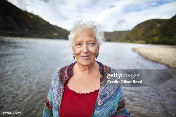 portrait of senior woman at river - portrait waist up stock pictures, royalty-free photos & images