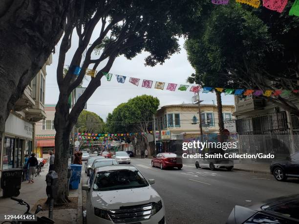 Photograph of cars parked and driving along Shotwell Street in the Mission District in San Francisco, California, December 25, 2020.