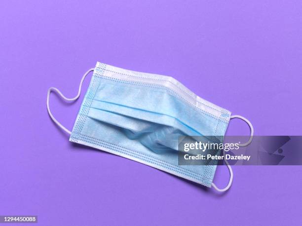 medical face mask on purple - face shield stock pictures, royalty-free photos & images