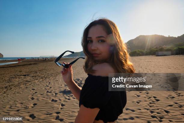 young girl posing with sun glasses - season 14 stock-fotos und bilder