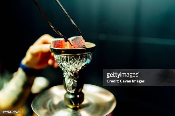 waiter placing smoking charcoal stones for shisha - hookah stock pictures, royalty-free photos & images