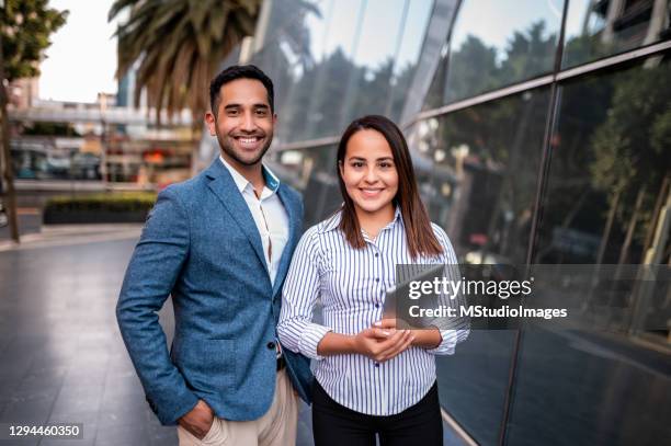 portrait of two young business persons - mexican business women stock pictures, royalty-free photos & images