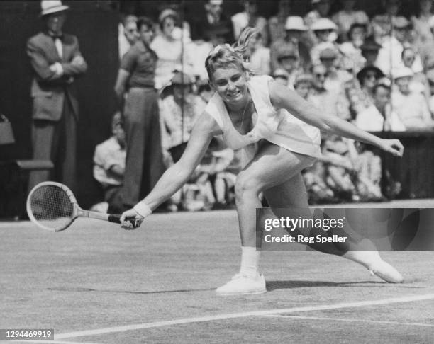 Darlene Hard of the United States reaches to make a forehand return to Althea Gibson of the United States during their Women's Singles Final match on...