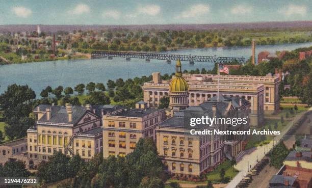 Vintage souvenir linen postcard published circa 1941 depicting an aerial view of the State Capital Building in downtown district of the industrial...