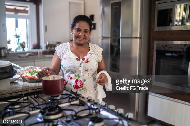 portrait of a mature woman cooking at home - brazilian culture stock pictures, royalty-free photos & images