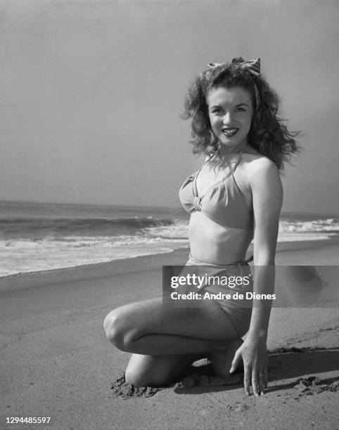 Portrait of American actress and model Marilyn Monroe in a bikini, as she poses at Zuma Beach's Paradise Cove, California, 1945.