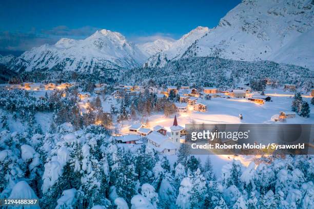 dusk on snowy woods and chiesa bianca, switzerland - village stock-fotos und bilder