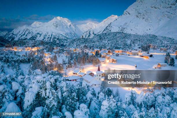 dusk on snowy woods and chiesa bianca, switzerland - sankt moritz fotografías e imágenes de stock