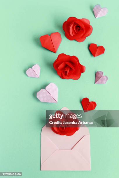 paper hearts  and paper roses on the pink envelope - origami flower stock pictures, royalty-free photos & images