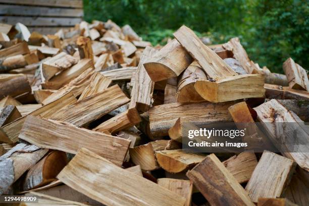wood pieces for firewood stacked waiting to be used in winter - firewood stock pictures, royalty-free photos & images