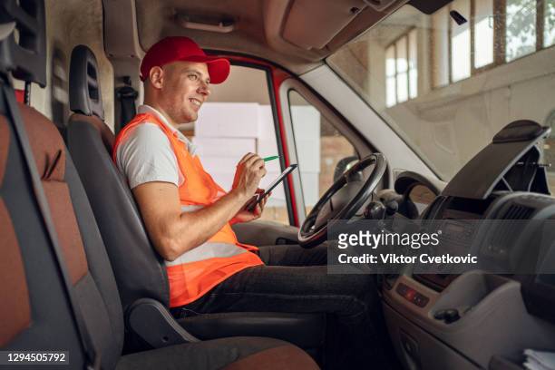 his deliveries are all digitally organized - tradesman van stock pictures, royalty-free photos & images