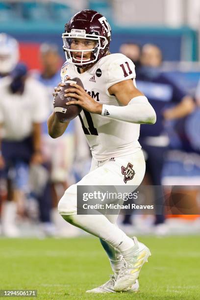 Kellen Mond of the Texas A&M Aggies scrambles with the ball against the North Carolina Tar Heels during the second half of the Capital One Orange...