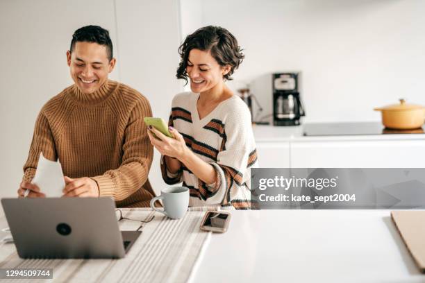 couple at home planning family budget - investments stock pictures, royalty-free photos & images