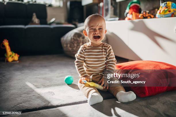 crying baby boy - baby toy stock pictures, royalty-free photos & images