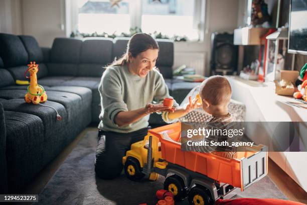 young mother and baby boy playing with toys - toy truck stock pictures, royalty-free photos & images