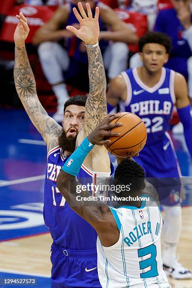 Vincent Poirier of the Philadelphia 76ers guards Terry Rozier of the ...