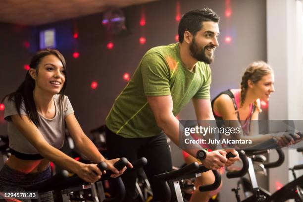 class with disco ambient lights, disco ambient light - stationary cycling class stock pictures, royalty-free photos & images