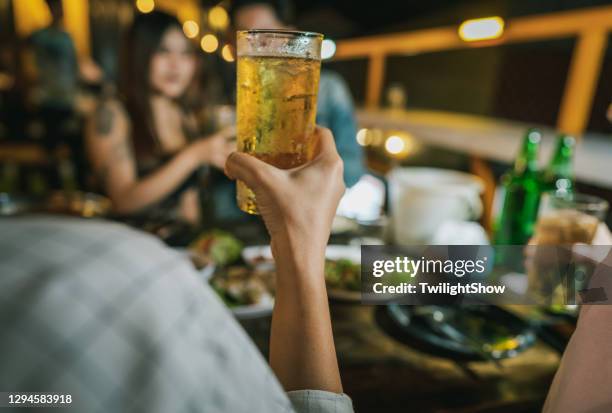 group of young asian friends having party drinking beer in outdoors restaurant - drunk asian women stock pictures, royalty-free photos & images