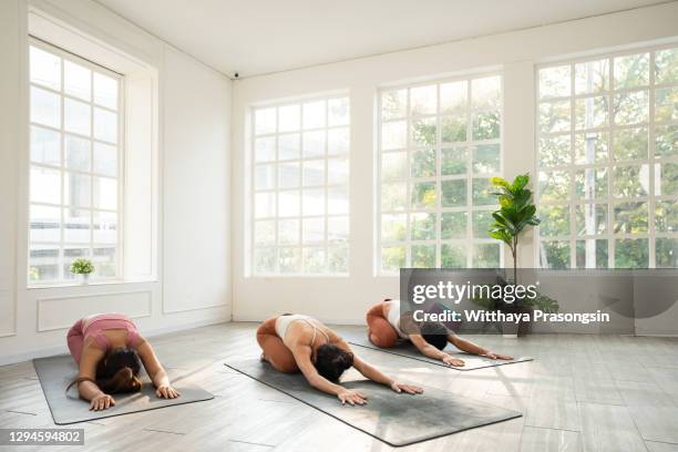 group of young sporty people in balasana pose - upright position stock pictures, royalty-free photos & images