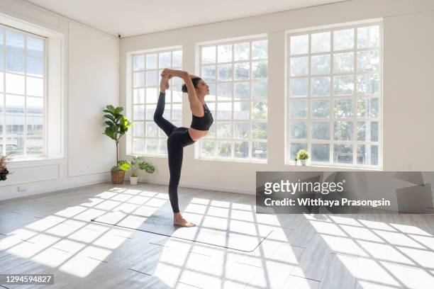 woman with arms raised yoga pose - yoga stock pictures, royalty-free photos & images