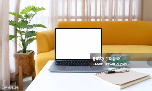 laptop computer blank white screen on table in cafe background. laptop with blank screen on table of coffee shop blur background. - laptop on desk no people stock pictures, royalty-free photos & images