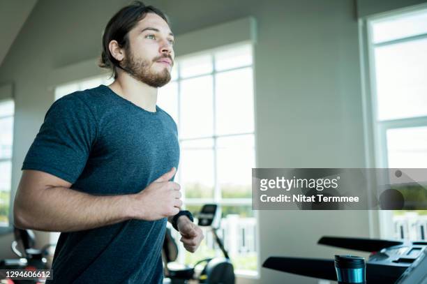 sport men running exercise on a treadmill in a health club. healthly lifestyle and self improvement concepts. - regular man stock pictures, royalty-free photos & images