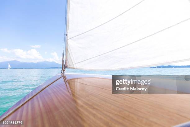 close-up of a white sail oder jib and the deck of a sailboat. - boat deck background stock pictures, royalty-free photos & images