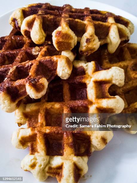 liege waffles freshly baked on a plate - waffles stock pictures, royalty-free photos & images