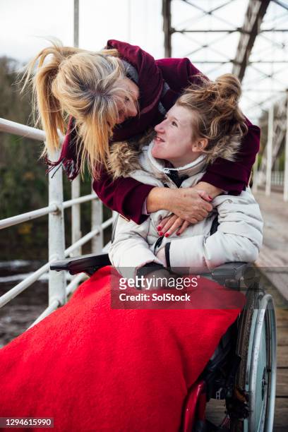 mother and daughter happy on an autumn walk - teenager cerebral palsy stock pictures, royalty-free photos & images