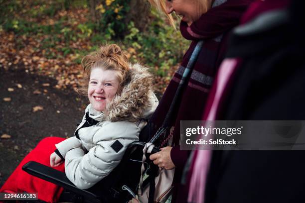 lovely autumnal walk - teenager cerebral palsy stock pictures, royalty-free photos & images