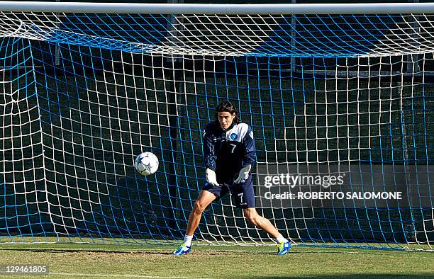 Napoli's forward Edinson Cavani takes a turn as goalkeeper during a training session at SSC Napoli's training facility in Castelvolturno on October...