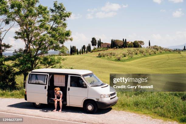 female tourist in a camper van in tuscany - mini van driving stock pictures, royalty-free photos & images