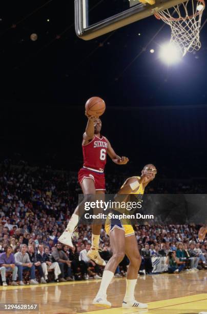 Julius Erving, Small Forward for the Philadelphia 76ers makes a one handed lay up to the basket over Kareem Abdul-Jabbar, Center for the Los Angeles...