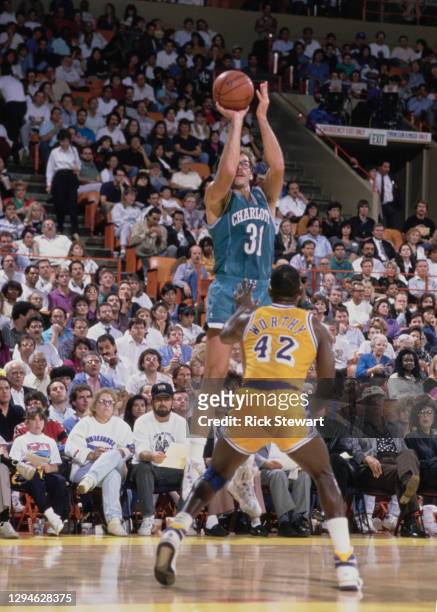 Kurt Rambis, Power Forward for the Charlotte Hornets attempts a three point jump shot to the basket over James Worthy of the Los Angeles Lakers...