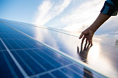 Hands on solar panel that generates energy
