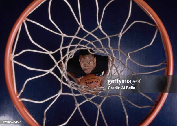 Allen Iverson, Shooting Guard and Point Guard for the Philadelphia 76ers looks up through the net of the basketball hoop during a photoshoot for...